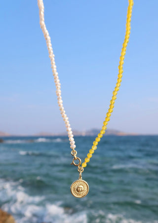 Freshwater pearls and yellow agate gemstone necklace with a gold-plated sun charm made in Greece by Greek jewelry designer brand Barbora.