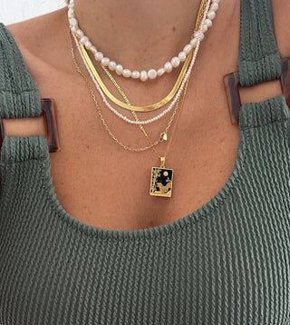 Necklace stack featuring a short freshwater pearl necklace made in Greece (Greek jewelry)