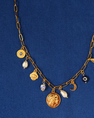 Gold charm necklace made in greece with Alexander the Great and vergina sun coin charm, evil eye charms, and freshwater pearls. Greek jewelry with ancient coin design
