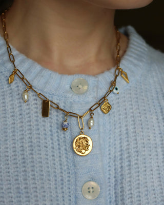 Gold charm necklace made in greece with Alexander the Great and vergina sun coin charm, evil eye charms, and freshwater pearls. Greek jewelry with ancient coin design