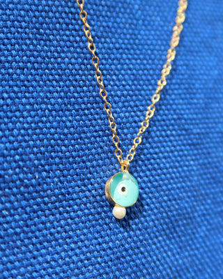 Turquoise glass evil eye necklace with a freshwater pearl accent. 14k gold-plated sterling silver 925 necklace handcrafted in Greece, Greek jewelry for protection, Greek designer brand