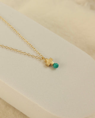 Gold-plated sterling silver mini cross necklace with a turquoise blue bead at the bottom, made in Greece. Cross necklace Greek jewelry