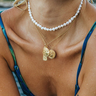 Freshwater pearl necklace on a model at the beach with a summer aesthetic - jewelry made in Greece