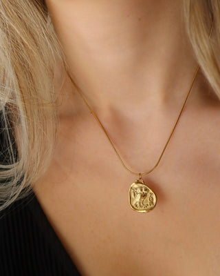 Woman wearing a gold necklace with coin pendant featuring greek goddess Athena's Owl of widsom from tetradrachm ancient Greek coins. Coin necklace made in Greece, Greek jewelry mythology-inspired