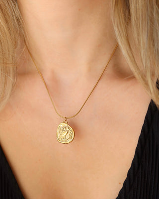 Woman wearing a gold necklace with coin pendant featuring greek goddess Athena's Owl of widsom from tetradrachm ancient Greek coins. Coin necklace made in Greece, Greek jewelry mythology-inspired