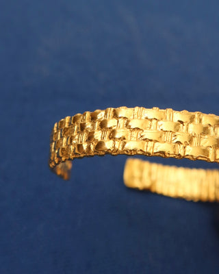Gold basketweave cuff bracelet on a wrist, made in Greece. Greek handmade jewelry