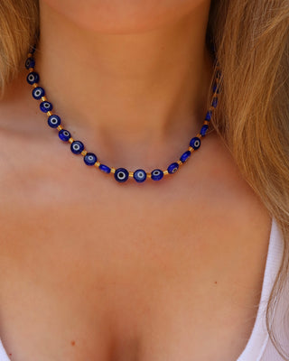 Woman wearing a blue glass evil eye choker necklace made in Greece, Greek jewelry