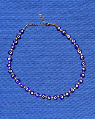 Necklace with dark blue glass evil eye beads and gold accents