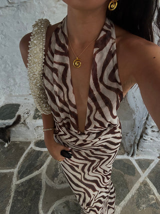 Model wearing a gold spiral pendant necklace made in Greece, Greek jewelry, Greek designer brand, trendy jewelry, recylced sterling silver 925 18k gold-plated necklace on a Greek island summer