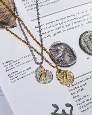 Two necklaces with Greek coin pendants (replicas of ancient Greek Athenian Tetradrachm coins with Athena Owl of Wisdom) on a background of ancient Greek artifacts and text.