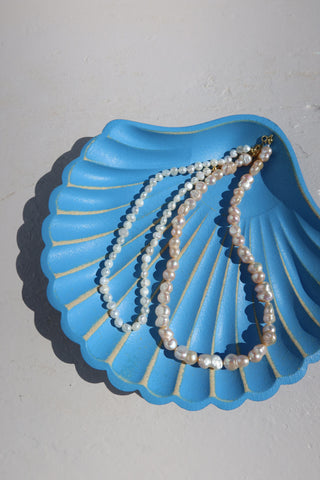 Freshwater pearl necklaces made in Greece on a shell dish - Greek jewelry