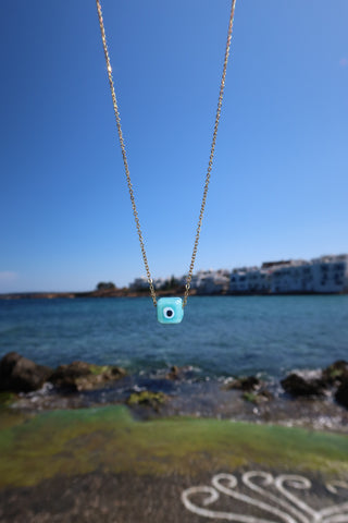 Turquoise hand-painted evil eye cube on a gold-plated necklace - jewelry made in Greece.