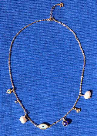 Gold plated evil eye necklace made in Greece with various evil eye charms and baroque freshwater pearls at Aegean Essence