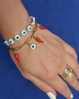 Gold paperclip chain bracelet with a white evil eye charm and red Italian cornicello charms for good luck, lucky charm bracelet made in Greece