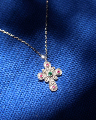 Sterling silver 925 cross pendant necklace in a Byzantine style with a green emerald stone at the center and ruby stones around the cross