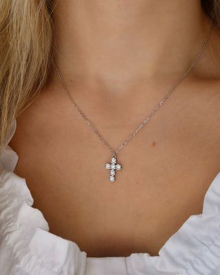 Woman wearing a sterling silver 925 chain necklace with a hexagonal cubic zirconia cross pendant made in Greece. Greek jewelry