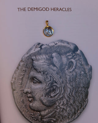 18k gold-plated sterling silver ancient Greek coin replica pendant of Heracles / Hercules wearing a lion skin with bale made in Greece on a book with the ancient coin