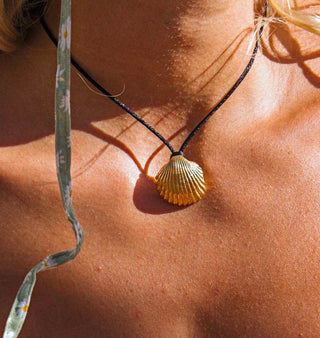 Black silky cord necklace with a gold-plated shell pendant, made in Greece by Greek jewelry brand Zenais. Zénaïs Hellas adjustable seashell necklace