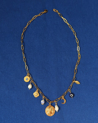 Gold charm necklace made in greece with Alexander the Great and vergina sun coin charm, evil eye charms, and freshwater pearls. Greek jewelry with ancient coin design