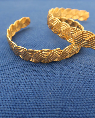Gold cuff bracelets with a braided wave design made in Greece, Greek jewelry