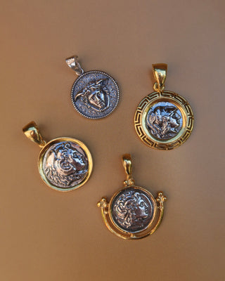 Four 18k gold-plated and sterling silver ancient Greek coin pendants featuring Medusa, Alexander the Great, Athena, and Heracles (Hercules) with oxidized effect. Replica coin jewelry made in Greece