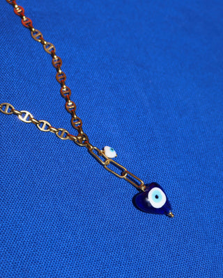 Gold stainless steel lariat necklace with a blue glass heart shape evil eye pendant and a white heart-shaped evil eye charm handmade in Greece. Greek protection jewelry, Y necklace