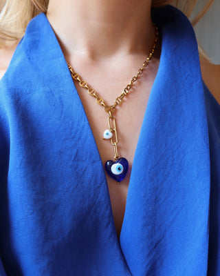 Gold stainless steel lariat necklace with a blue glass heart shape evil eye pendant and a white heart-shaped evil eye charm handmade in Greece. Greek protection jewelry, Y necklace