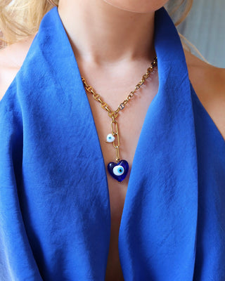 Gold stainless steel lariat necklace with a blue glass heart shape evil eye pendant and a white heart-shaped evil eye charm handmade in Greece. Greek protection jewelry, Y necklace