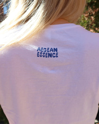 White t-shirt with blue Aegean Essence logo on the upper back