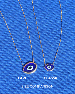 Size comparison of two dark blue Murano glass evil eye necklaces, one large and one small