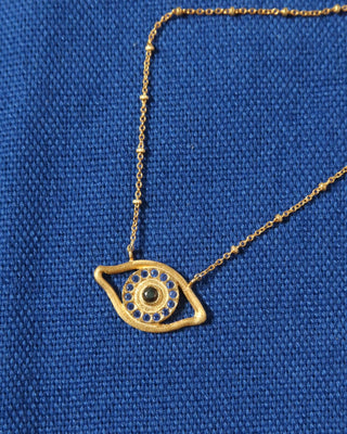 Gold plated necklace with an eye-shaped pendant on a person's neck - Greek evil eye jewelry made in Greece made with sterling silver 925 in the design of Homer's Odyssey eye on odysseus's ship