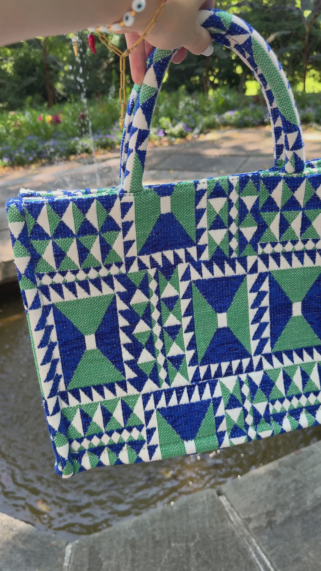 Video of a woven royal blue and green geometric print top handle handbag large tote bag