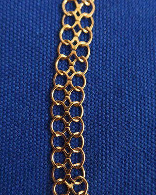 Gold chain on a blue textured background